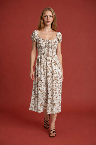 Effortlessly feminine and perfectly polished, this floral toile midi dress is a wardrobe essential you'll reach for again and again. The charming scoop neckline and front tie detail add a playful, put-together touch, while the elastic shirred waist flatters every figure and keeps you comfortable all day long.
