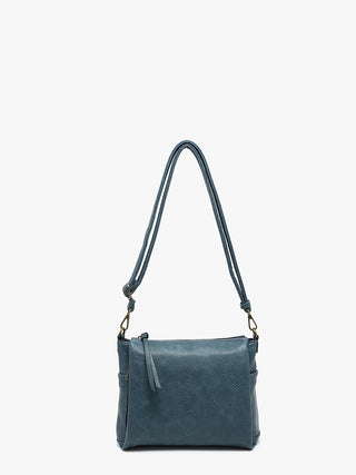 Designed with a stylish distressed finish and smart organization, this versatile crossbody features three spacious compartments and multiple exterior pockets to keep your essentials within easy reach. Complete with an adjustable/removable crossbody strap, it's the perfect everyday companion.