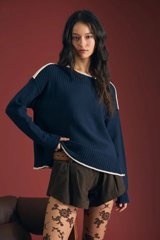 Everyday style with a little extra personality. This knit pullover sweater pairs a boat neckline with long sleeves and extended, dropped shoulders for a laid-back look. Contrast trim, raw edges, and exposed seams give this wardrobe staple a fresh twist, while ribbed detailing adds texture.