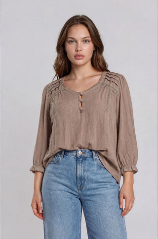 The V-neckline with delicate crochet lace trim adds a bohemian-chic touch, while pintuck shoulder details and a back yoke with gathered detail give it a beautifully tailored feel.