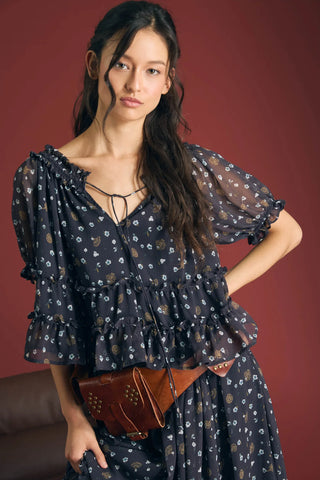 A little floral charm goes a long way. This lightweight woven top pairs a round neckline with smocked detailing and a front tie with a keyhole accent for a sweet finishing touch. Short puff sleeves and ruffle trim add a romantic feel, while the relaxed fit keeps your look effortlessly easy.